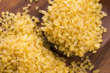 Image showing bulgur wheat in wooden spoon