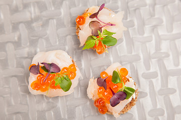 Image showing Salmon eggs, fish, and herbs canapes