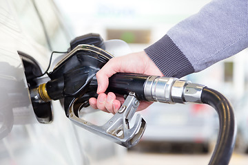 Image showing Petrol being pumped into a motor vehicle car.