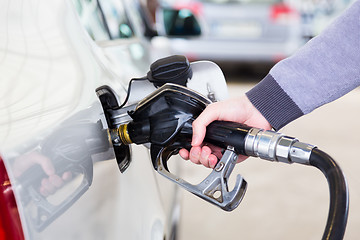 Image showing Petrol being pumped into a motor vehicle car.