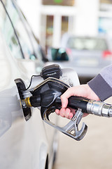 Image showing Petrol being pumped into a motor vehicle car.