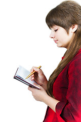 Image showing Beautiful young girl with notebook and pen on a white