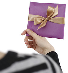 Image showing Young woman holding a present