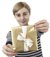 Image showing Young woman holding a present