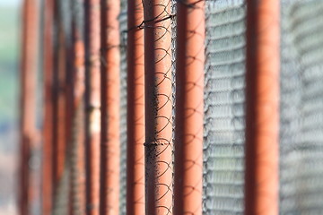 Image showing perspective view of rusty metal fence