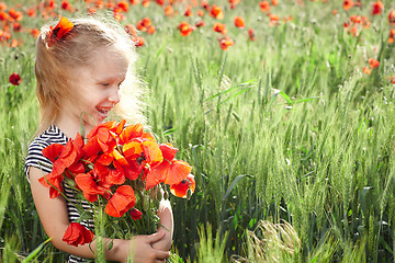 Image showing Little girl on the poppy meadow with posy