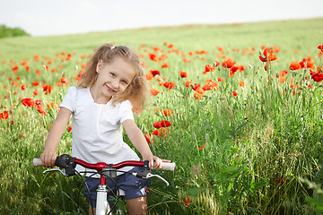 Image showing Happy smiling little girl with bicycle