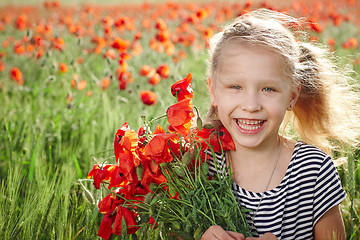 Image showing Happy laughing little girl  on the poppy meadow