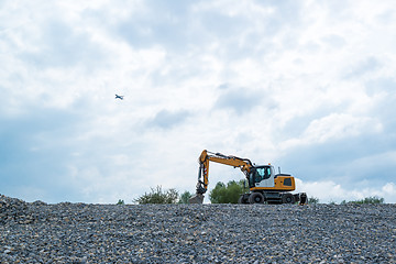 Image showing Excavator and plane