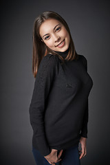 Image showing Closeup portrait of smiling teen female in black pullover