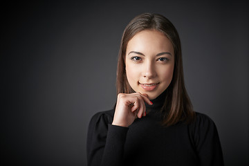 Image showing Closeup portrait of smiling teen female in black pullover