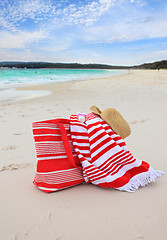 Image showing Beach bag towel and hat on the sand