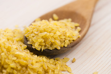 Image showing bulgur wheat in wooden spoon