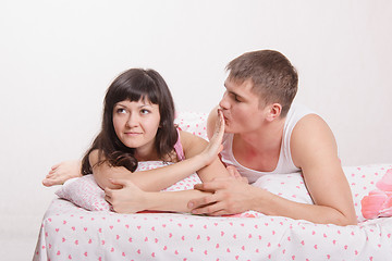 Image showing Young girl refuses to kiss a guy in bed