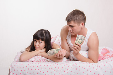 Image showing Guy offers offended girl money