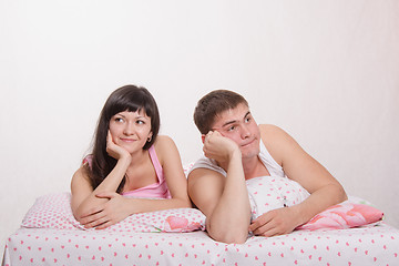 Image showing Young happy girl and guy in bed dreaming