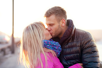 Image showing Couple kissing in winter warm clothes