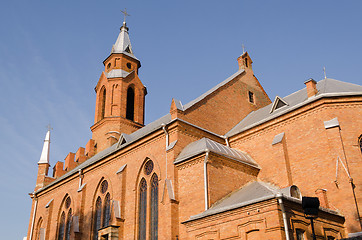 Image showing gothic church with crosses on blue sky background 