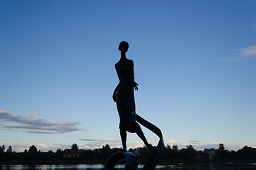 Image showing woman sculpture with wavy ribbon  by night dark  