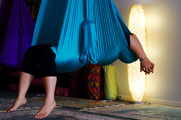 Image showing person suspended in blue aerial yoga hammock