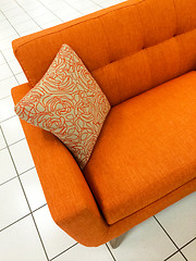 Image showing Orange sofa with decorative cushion