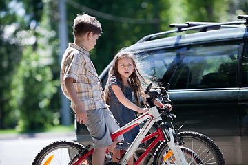 Image showing Young boy and girl taking a break from bicycling