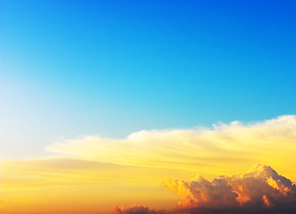 Image showing red, yellow and orange clouds on blue sky