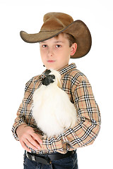 Image showing Country boy holding a chicken