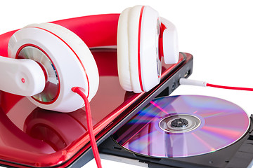 Image showing Red headphones and laptop with compact disk