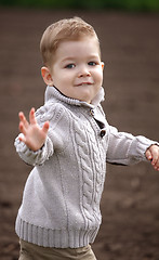 Image showing happy 2 years old baby boy in motion