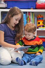 Image showing Girl with her little brother fun using a digital tablet computer