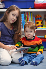 Image showing Girl with her little brother fun using a digital tablet computer