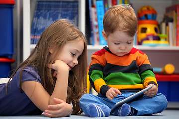 Image showing Girl with her little brother fun using a digital tablet computer