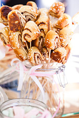 Image showing Small cinnamon buns on sticks