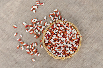 Image showing organic beans in wicker basket on linen texture  