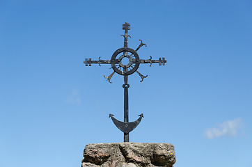 Image showing metal ornamented cross on blue sky background 
