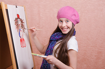 Image showing Happy little girl draws a picture