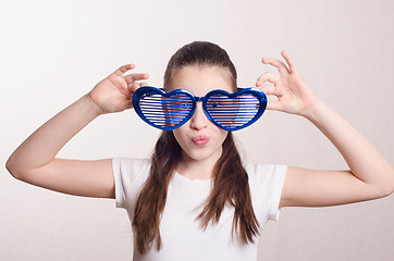 Image showing Smiling girl in big funny glasses