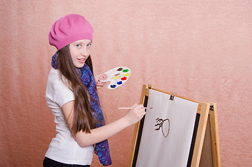 Image showing The girl begins to draw picture on the easel