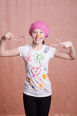 Image showing Happy cheerful girl with a painted paint brushes