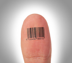 Image showing Thumb finger over a white background, barcode