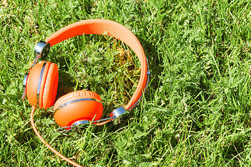 Image showing Vibrant orange wired headphones