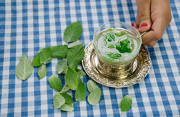 Image showing woman hand hold cup with healing relaxing mint tea 
