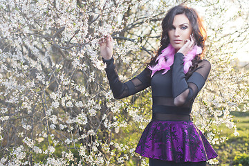 Image showing Fashion spring girl with pink feather earrings