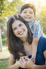 Image showing Attractive Mixed Race Mother and Son Hug in Park