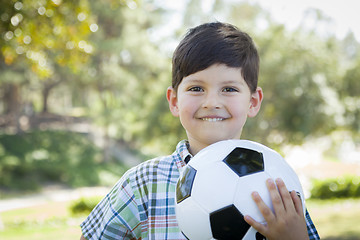 Image showing Cute Young Boy Playing with Soccer Ball in Park