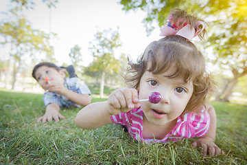 Image showing Cute Baby Girl and Brother with Lollipops in Park