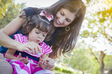 Image showing Young Mother and Cute Baby Girl Applying Fingernail Polish