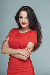 Image showing Bright smiling business woman in red dress