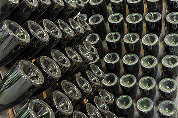 Image showing Rack stand with dusty bottles